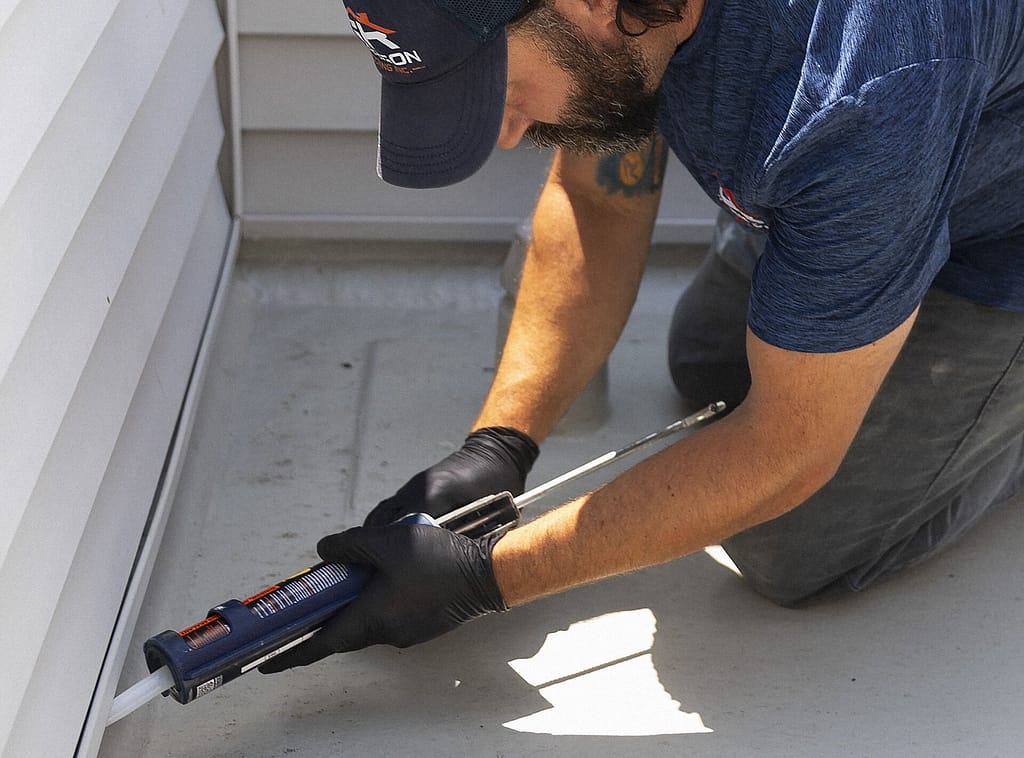 Roofer sealing flashing on a Philadelphia roof