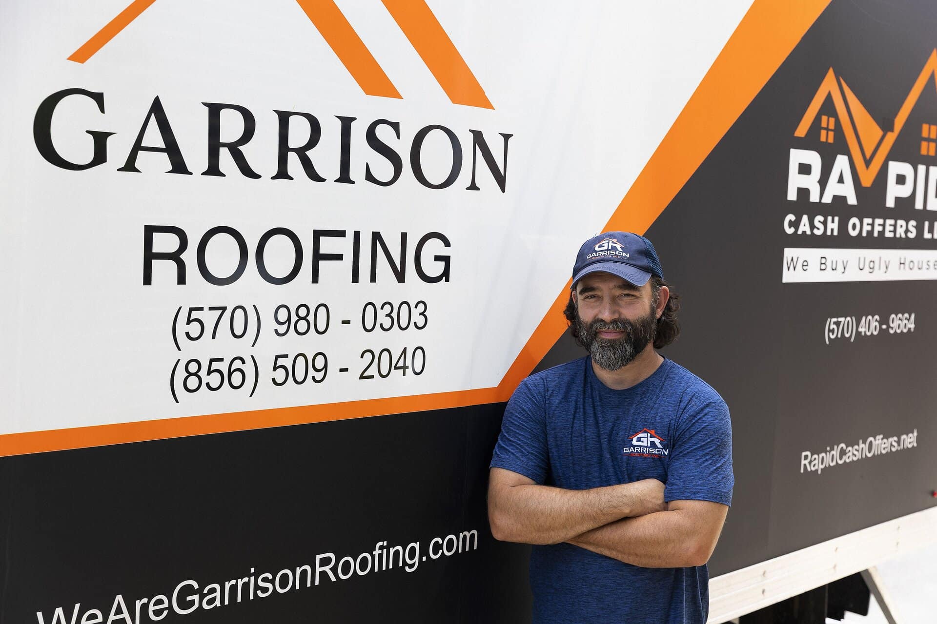 Rob Garrison in front of a Garrison Roofing truck in Philadelphia