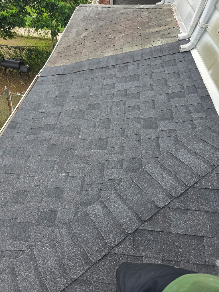 Storm-damaged shingle roof awaiting repair